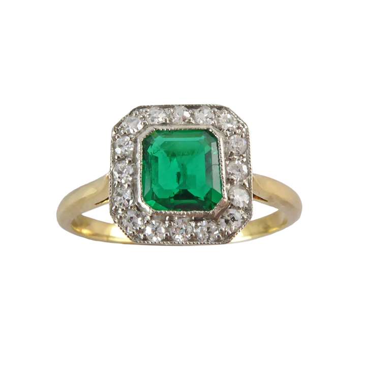 Emerald and diamond cluster ring, of cut-corner rectangular outline, the emerald cut emerald approximately 0.55ct,